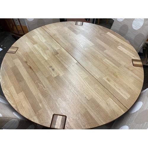 138 - LIGHT OAK CIRCULAR DINING TABLE AND FOUR FABRIC COVERED HIGH BACK CHAIRS