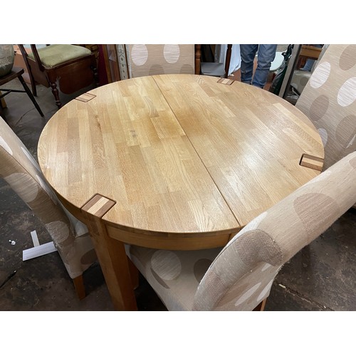 138 - LIGHT OAK CIRCULAR DINING TABLE AND FOUR FABRIC COVERED HIGH BACK CHAIRS