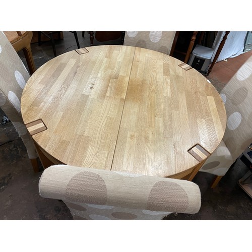 138 - LIGHT OAK CIRCULAR DINING TABLE AND FOUR FABRIC COVERED HIGH BACK CHAIRS