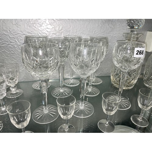 268 - SHELF CONTAINING WATERFORD CANDLE HOLDERS, CUT GLASS WINE FLUTES, AND TWO DECANTERS