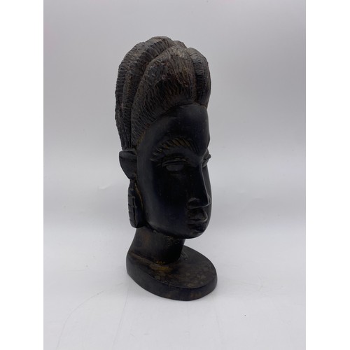 517 - FOUR CARVED WOOD AFRICAN BUSTS