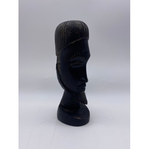 517 - FOUR CARVED WOOD AFRICAN BUSTS