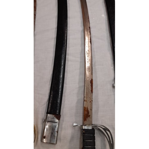 223 - FOUR REPRODUCTION CEREMONIAL SWORDS AND ONE OTHER IN RED SCABBARD