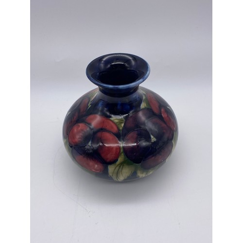 494 - MOORCROFT POTTERY PANSY PATTERN SQUAT BULBOUS VASE ON DARK BLUE GROUND