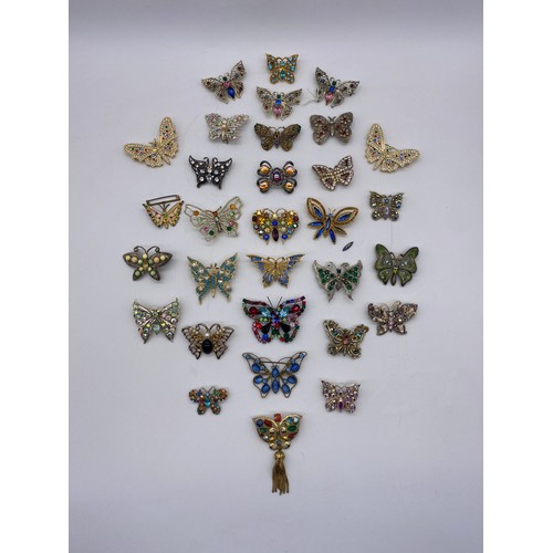 606 - BAG OF LARGE DIAMANTE AND PASTE BUTTERFLY BROOCHES