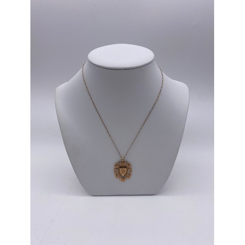 593 - 9CT ROSE GOLD SHIELD PENDANT ON TRACE CHAIN 5.5G APPROX