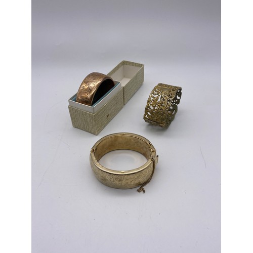 588 - CASED ROLLED GOLD ROSE COLOURED CUFF BANGLE WITH ENGRAVED DECORATION PLUS ONE OTHER AND A STAMPED 80... 