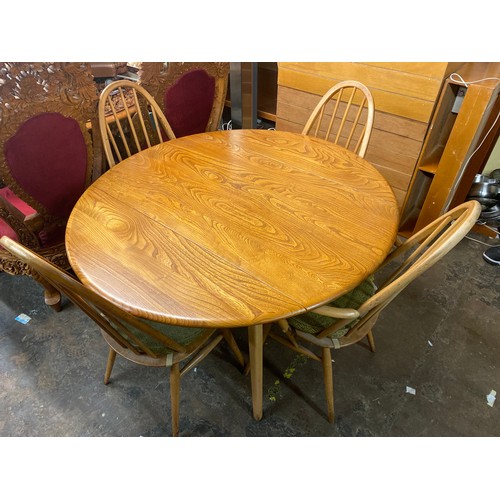 72 - ERCOL ELM DROP FLAP CIRCULAR DINING TABLE AND FOUR HOOP BACK CHAIRS