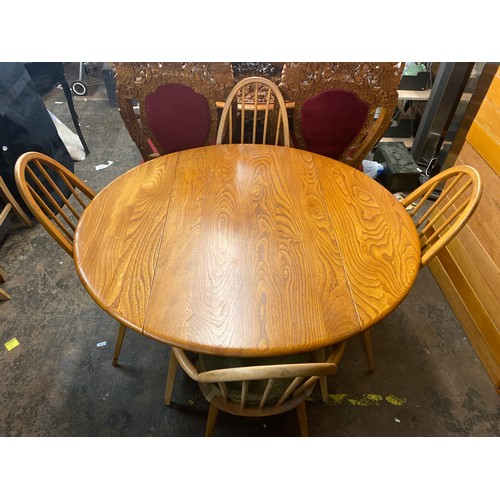 72 - ERCOL ELM DROP FLAP CIRCULAR DINING TABLE AND FOUR HOOP BACK CHAIRS