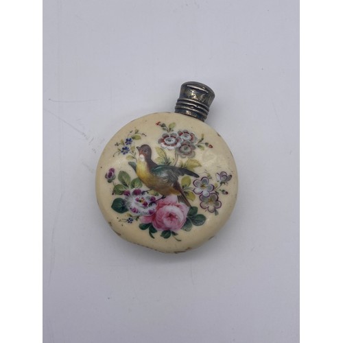 219 - WHITE METAL HINGED LID PORCELAIN MOON FLASK SCENT BOTTLE PAINTED WITH BIRDS AMIDST FLORAL SPRAYS