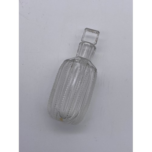 231 - CLEAR GLASS CYLINDRICAL BOTTLE WITH COMPRESSED STOPPER AND A ROUNDED EDGE CUT GLASS EXAMPLE