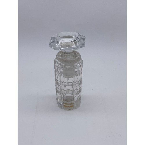 231 - CLEAR GLASS CYLINDRICAL BOTTLE WITH COMPRESSED STOPPER AND A ROUNDED EDGE CUT GLASS EXAMPLE