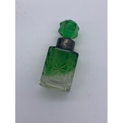 213 - TWO GREEN FLUTED PANELLED SCENT BOTTLES AND A GREEN SILVER COLLARED SQUARE SECTION SCENT BOTTLE