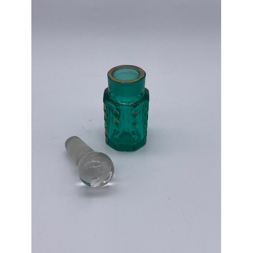 213 - TWO GREEN FLUTED PANELLED SCENT BOTTLES AND A GREEN SILVER COLLARED SQUARE SECTION SCENT BOTTLE