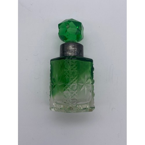 213 - TWO GREEN FLUTED PANELLED SCENT BOTTLES AND A GREEN SILVER COLLARED SQUARE SECTION SCENT BOTTLE