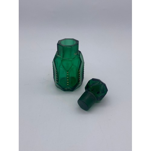 213 - TWO GREEN FLUTED PANELLED SCENT BOTTLES AND A GREEN SILVER COLLARED SQUARE SECTION SCENT BOTTLE