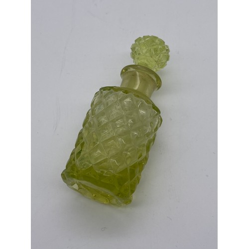 244 - TINTED GREEN GLASS SCREW TOP MOON FLASK SCENT BOTTLE, TWO VASELINE GLASS BOTTLES AND ONE GRADUATED B... 