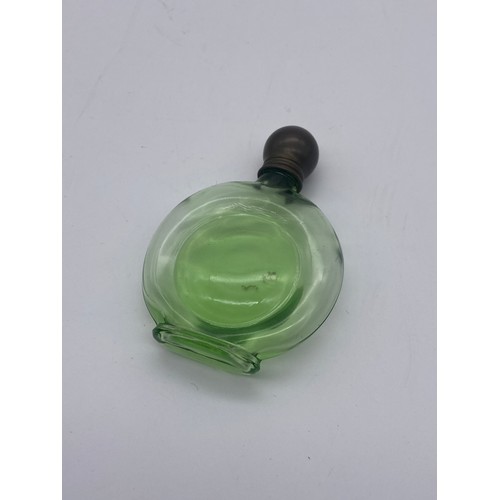 244 - TINTED GREEN GLASS SCREW TOP MOON FLASK SCENT BOTTLE, TWO VASELINE GLASS BOTTLES AND ONE GRADUATED B... 