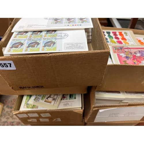 557 - SEVEN BOXES OF POST OFFICE FIRST DAY COVERS AND POSTCARDS INCLUDING DUPLICATES