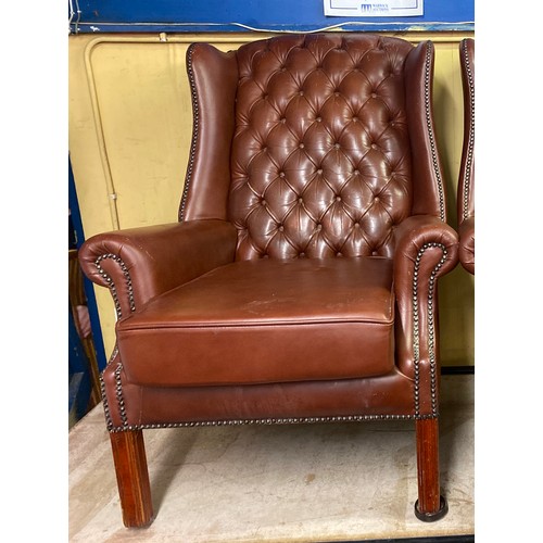 45 - BROWN STUDDED AND BUTTON BACK LEATHER WING ARMCHAIR