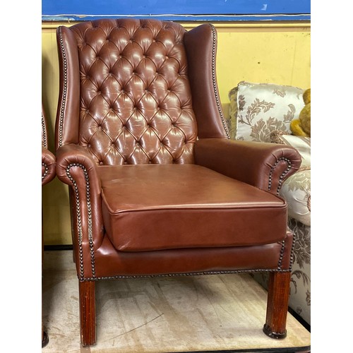 44 - BROWN STUDDED AND BUTTON BACK LEATHER WING ARMCHAIR