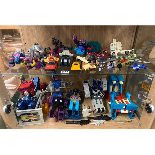 511 - TWO SHELVES OF TRANSFORMER ACTION FIGURES