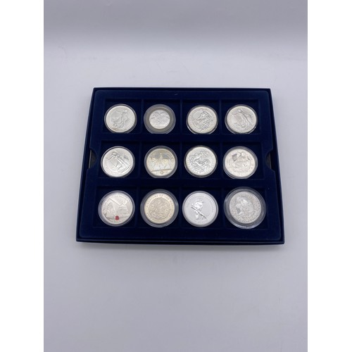 401 - BOX OF 12 ONE OUNCE SILVER BRITANNIA COMMEMORATIVE CROWNS, AND A SILVER ONE DOLLAR KOOKABURRA