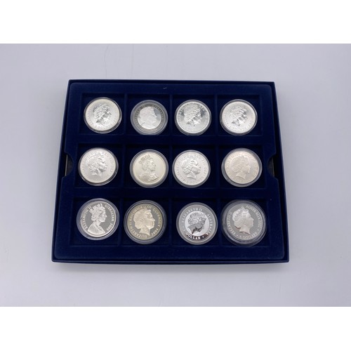 401 - BOX OF 12 ONE OUNCE SILVER BRITANNIA COMMEMORATIVE CROWNS, AND A SILVER ONE DOLLAR KOOKABURRA