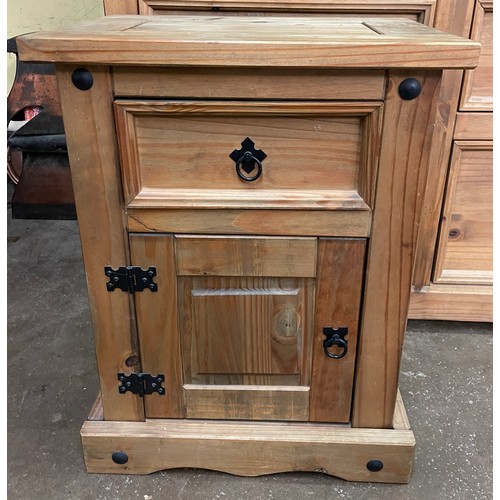 136 - COLONIAL PINE BEDSIDE CUPBOARD WITH METAL STUDDED MOUNTS