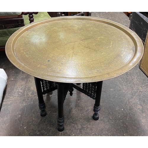 223 - EGYPTIAN ENGRAVED BRASS DISH TOP TABLE ON FOLDING EBONISED AND BONE STAND