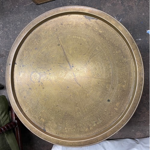 223 - EGYPTIAN ENGRAVED BRASS DISH TOP TABLE ON FOLDING EBONISED AND BONE STAND