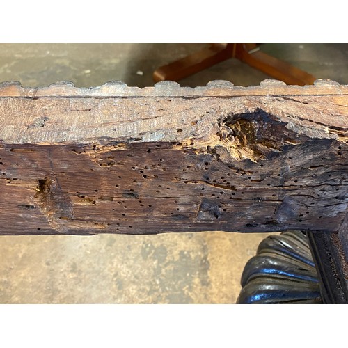 166 - 17TH CENTURY AND LATER OAK REFECTORY TABLE WITH A FIVE PLANK CLEATED TOP WITH CARVED EDGE ON HEAVILY... 