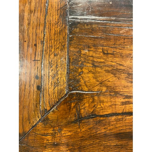 166 - 17TH CENTURY AND LATER OAK REFECTORY TABLE WITH A FIVE PLANK CLEATED TOP WITH CARVED EDGE ON HEAVILY... 