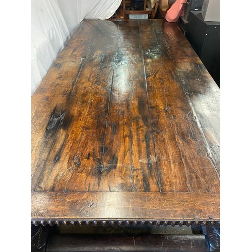 166 - 17TH CENTURY AND LATER OAK REFECTORY TABLE WITH A FIVE PLANK CLEATED TOP WITH CARVED EDGE ON HEAVILY... 