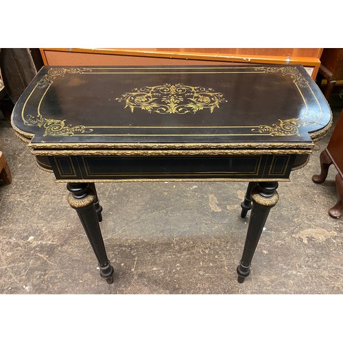 84 - NAPOLEAN III EBONISED CUT BRASS INLAID FOLD OVER CARD TABLE WITH GILT METAL MOUNTS, 86CM W X 75CM H ...