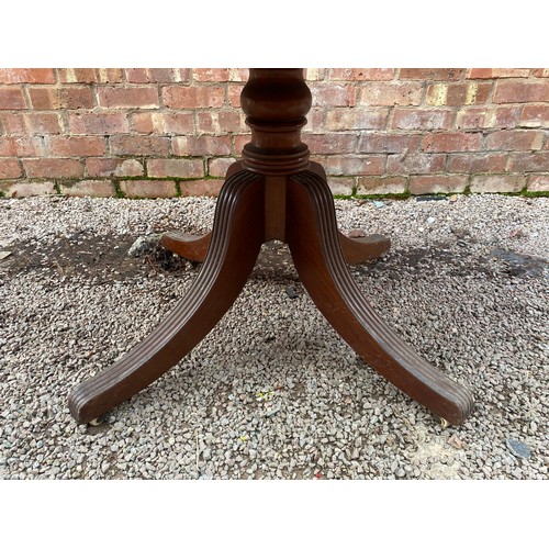 159 - VICTORIAN OVAL WALNUT TILT TOP TABLE ON A RING TURNED REEDED QUADRAPARTITE BASE