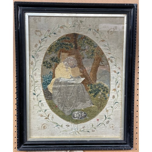 286 - BERLIN NEEDLE WORKED PANEL OF A SEATED LADY WRITING ON A SILK FLORAL BORDER 31CM X 40CM APPROX