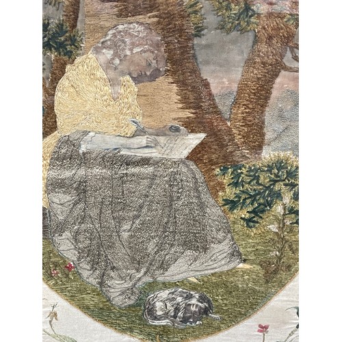 286 - BERLIN NEEDLE WORKED PANEL OF A SEATED LADY WRITING ON A SILK FLORAL BORDER 31CM X 40CM APPROX