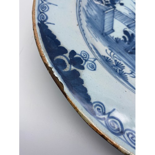 473 - 18TH CENTURY DELFT BLUE AND WHITE EARTHEN WARE CHARGER