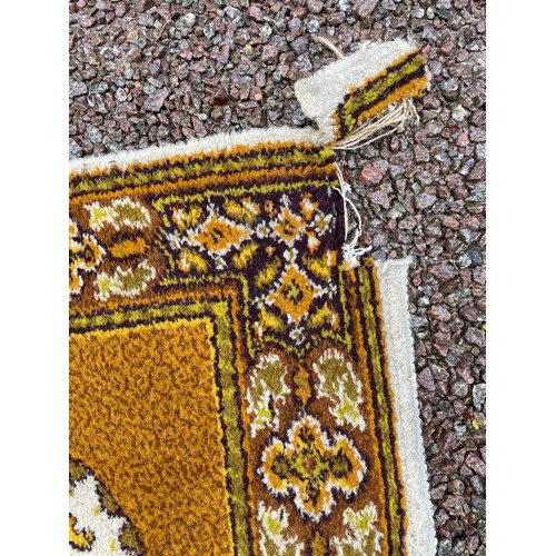 200 - CREAM AND BROWN PATTERNED ROLLED RUG A/F 184CM X 92CM