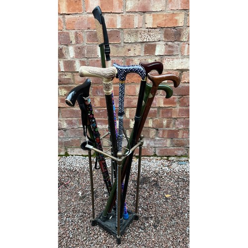 330 - BRASS FOUR SECTION CANE STAND WITH DRIP TRAY, VARIOUS CANES AND WALKING STICKS