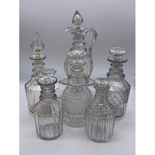 491 - FIVE 19TH CENTURY TRIPPLE RING AND PANELLED MALLET DECANTERS AND A CLARET JUG