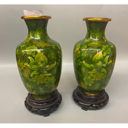 520 - PAIR OF GREEN CLOISONNE ENAMEL BALUSTER VASES ON HARDWOOD STANDS AND AN OVOID JAR WITH COVER ON HARD... 