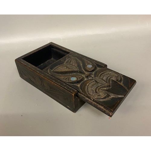 533 - TWO CARVED HARDWOOD BOXES, MAORI INSPIRED WITH PAUA SHELL INSET EYES