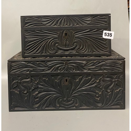 535 - TWO CHIP CARVED EBONY ANGLO INDIAN BOXES ONE WITH COMPARTMENTED TRAY LIDS A/F