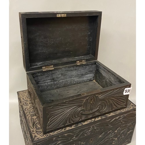 535 - TWO CHIP CARVED EBONY ANGLO INDIAN BOXES ONE WITH COMPARTMENTED TRAY LIDS A/F