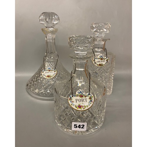 542 - THREE CUT GLASS DECANTERS WITH PORCELAIN SPIRIT LABELS