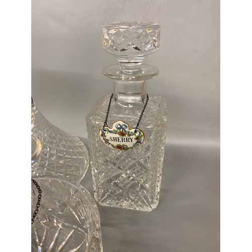 542 - THREE CUT GLASS DECANTERS WITH PORCELAIN SPIRIT LABELS