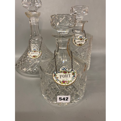 542 - THREE CUT GLASS DECANTERS WITH PORCELAIN SPIRIT LABELS