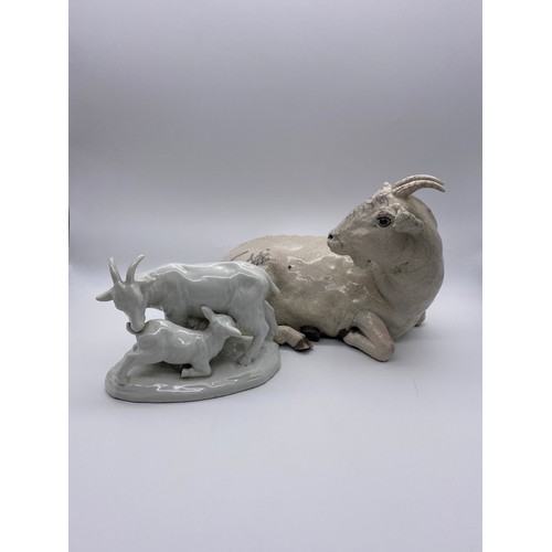 389 - POTTERY CRACKLE GLAZED RECUMBENT GOAT (EAR A/F ) AND A BLANC DE CHINE GOAT AND KID FIGURE GROUP